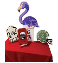 Decorative items including a purple flamingo, dog, book, and helmet on a red surface.